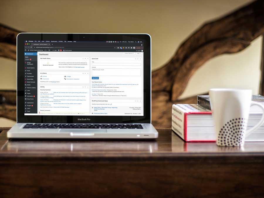 Wordpress dashboard on a macbook pro sat on coffee table